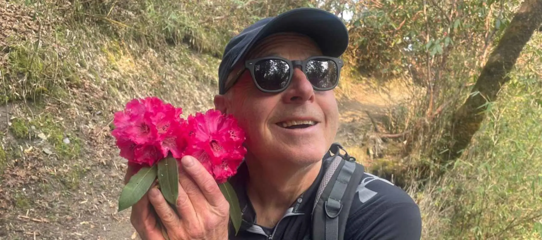 May Treks in Nepal - Tourist Enjoying wih Rhododendrons